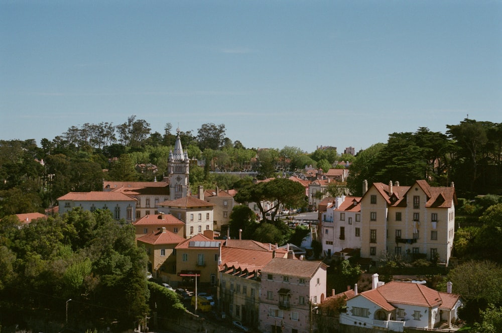 a view of a town with a church tower in the background