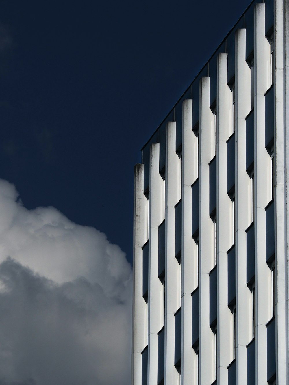 a tall white building with a clock on it's side