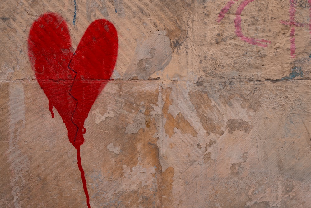 a red heart painted on the side of a wall