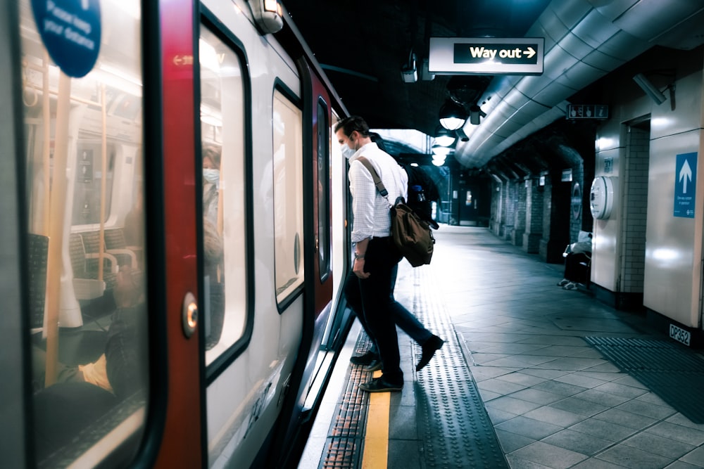 a couple of people that are standing next to a train