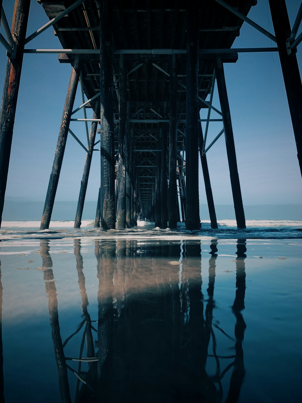 the underside of a pier on a clear day