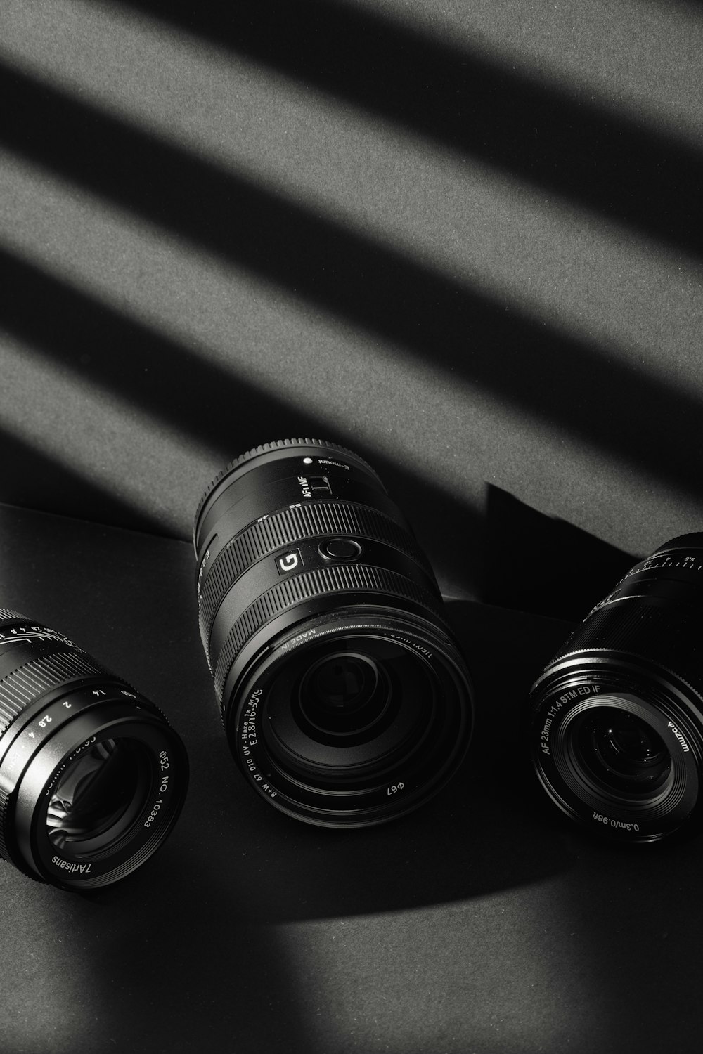 three cameras sitting next to each other on a table