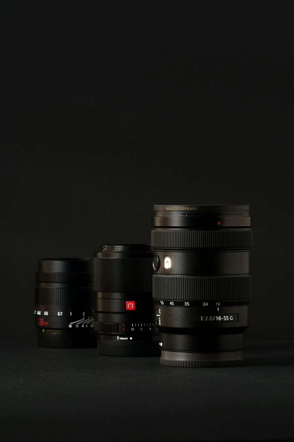 a group of three cameras sitting next to each other