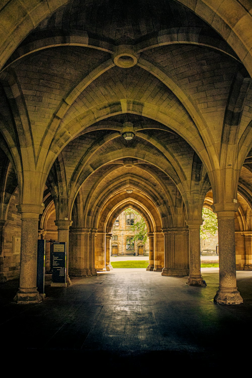 a large stone building with arches and a clock on the wall