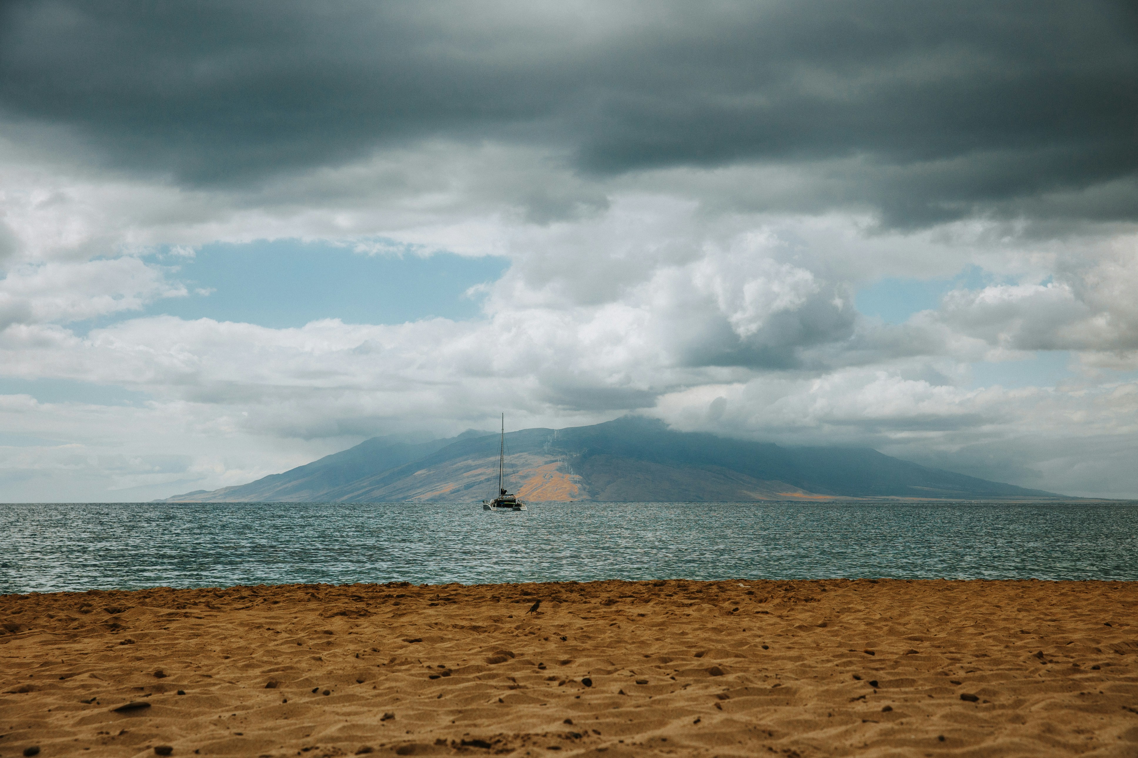 a boat floating on top of a large body of water, 