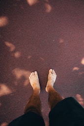 a person standing on the ground with their feet up