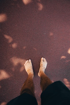 a person standing on the ground with their feet up