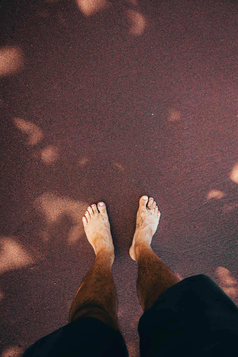 a person standing on the ground with their feet up