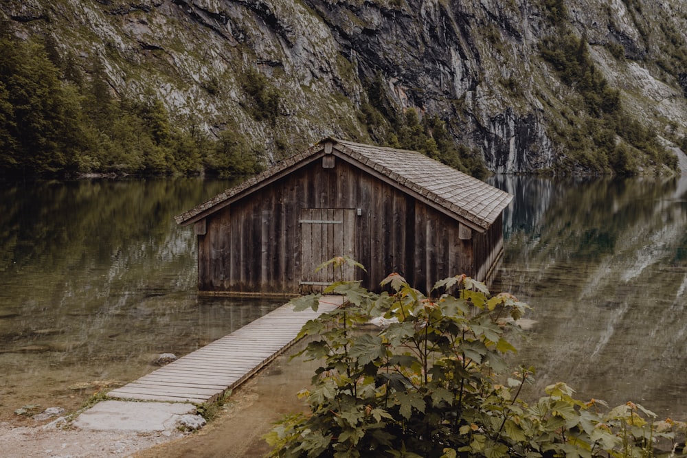 a boathouse on a lake with a dock in front of it