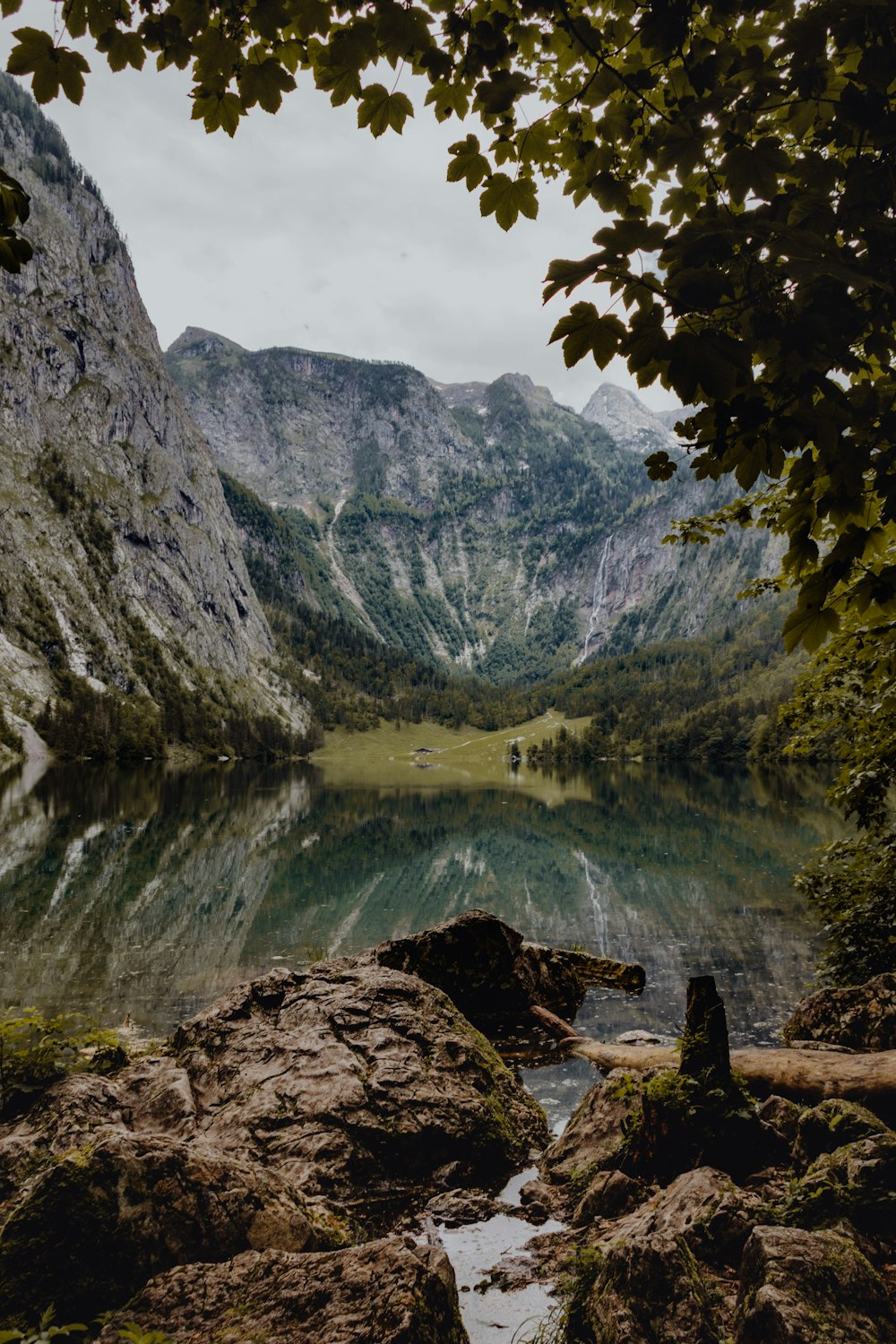 a lake surrounded by mountains and trees