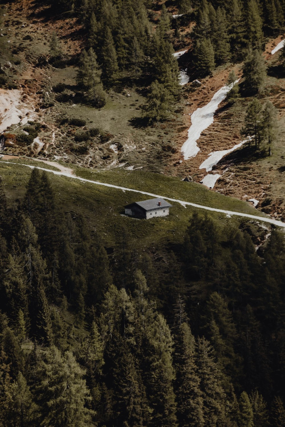 an aerial view of a house in the middle of a forest