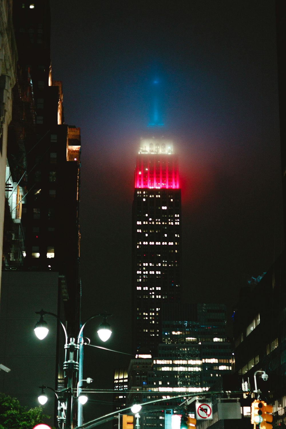 a very tall building lit up in the night sky