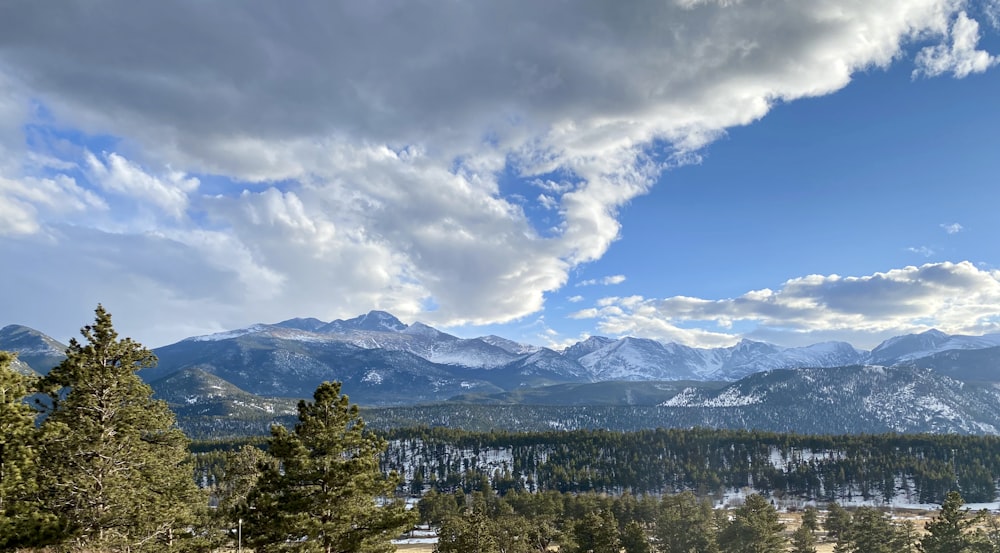 a scenic view of a mountain range with snow on the mountains