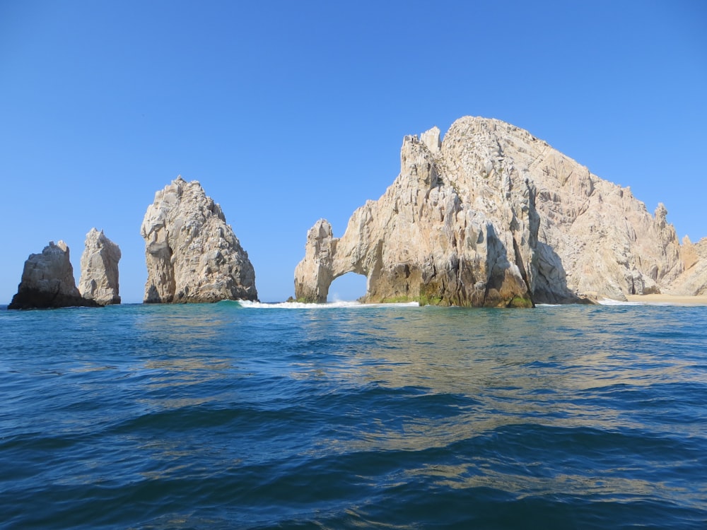 a large rock formation in the middle of the ocean