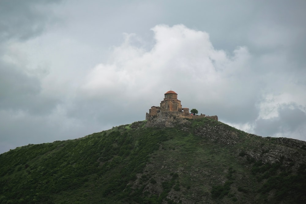 a castle sitting on top of a lush green hillside