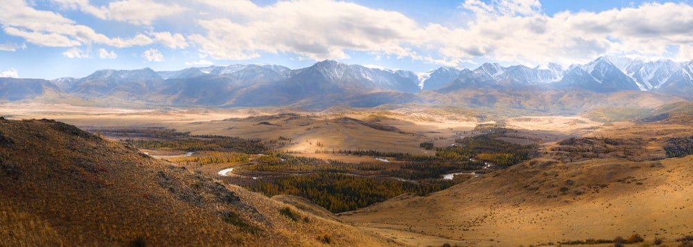 a view of a valley with mountains in the background