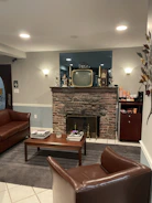 A cozy living room with a vintage TV showing a lively talk show in warm tones.