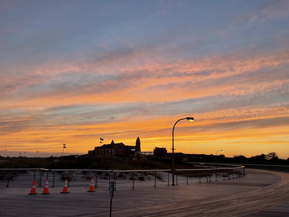 a sunset view of a city with a clock tower in the distance