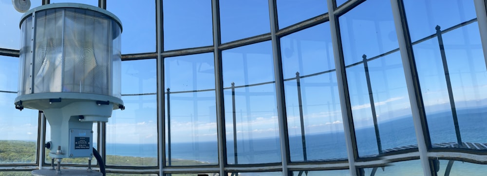 a glass building with a view of the ocean