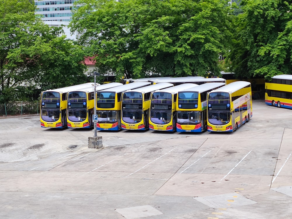 a group of buses parked in a parking lot