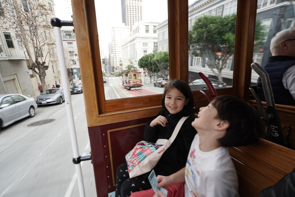 a couple of people that are sitting on a bus