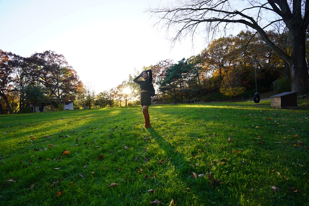 a person standing in a field with a frisbee