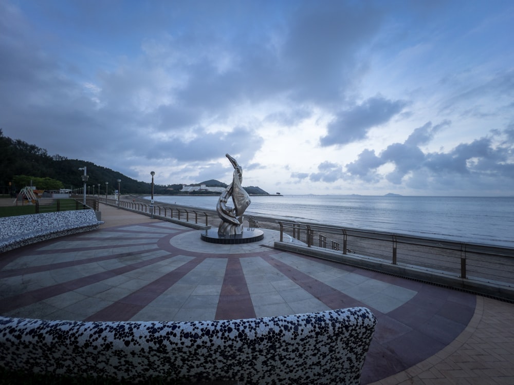 a statue of a woman is in the middle of a walkway