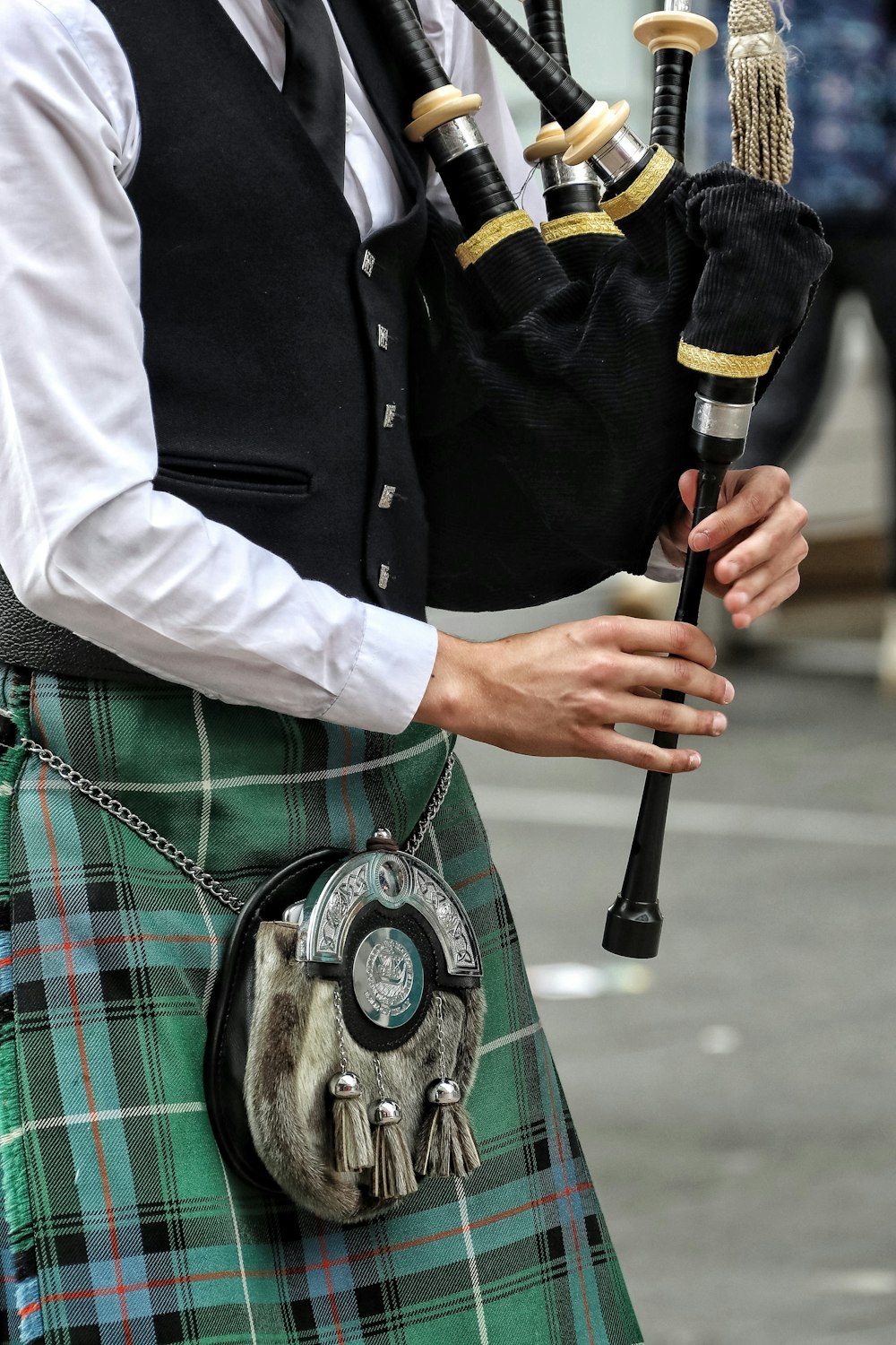 a man in a kilt holding a bagpipe