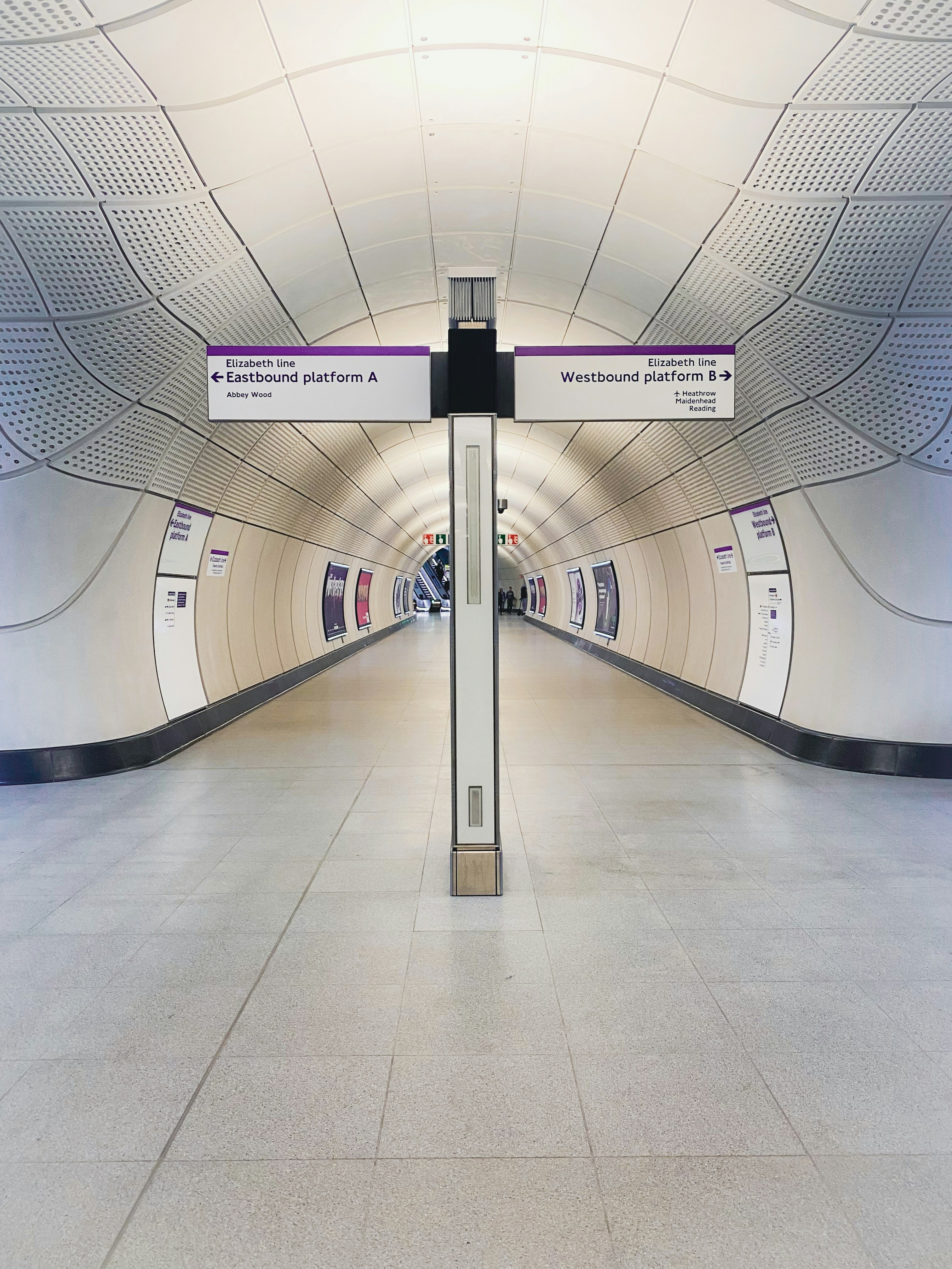 a long hallway with a sign on the side of it