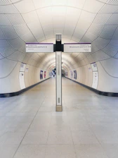 a long hallway with a sign on the side of it