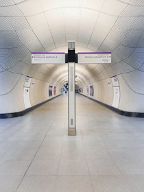 a long hallway with a sign on the side of it
