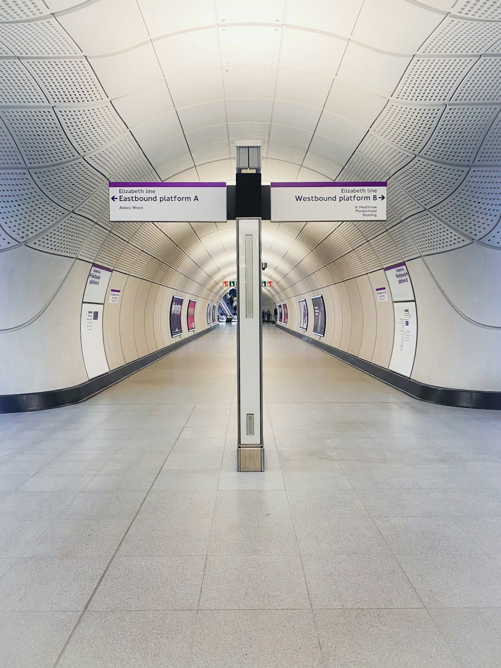 a long hallway with a sign on the side of it