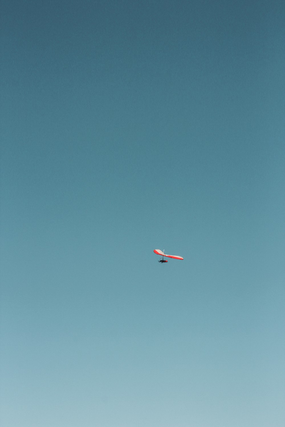 an airplane is flying in the blue sky