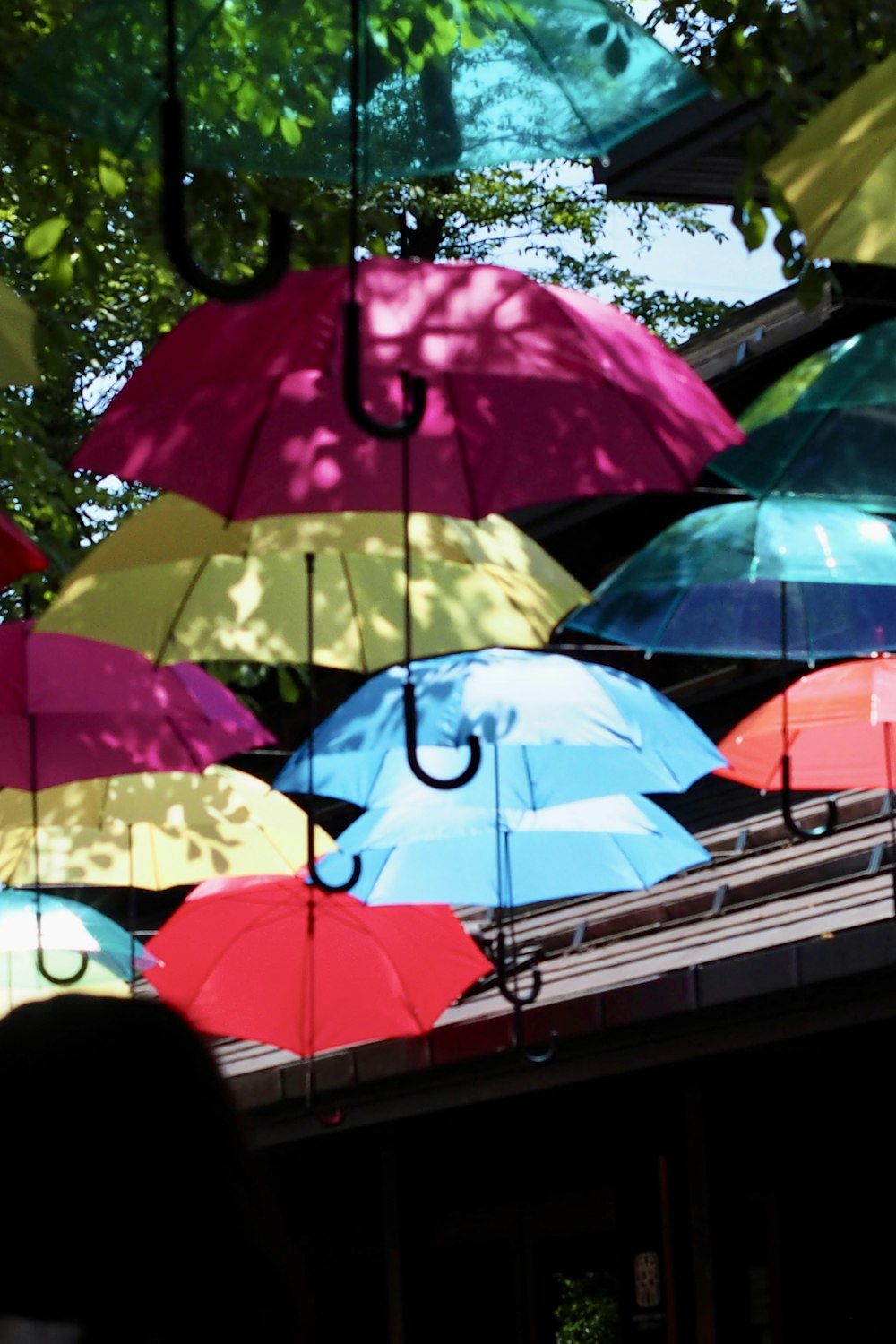 a group of colorful umbrellas hanging from a building