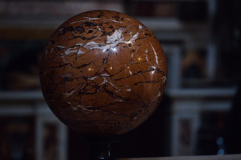 a marble ball sitting on top of a wooden table