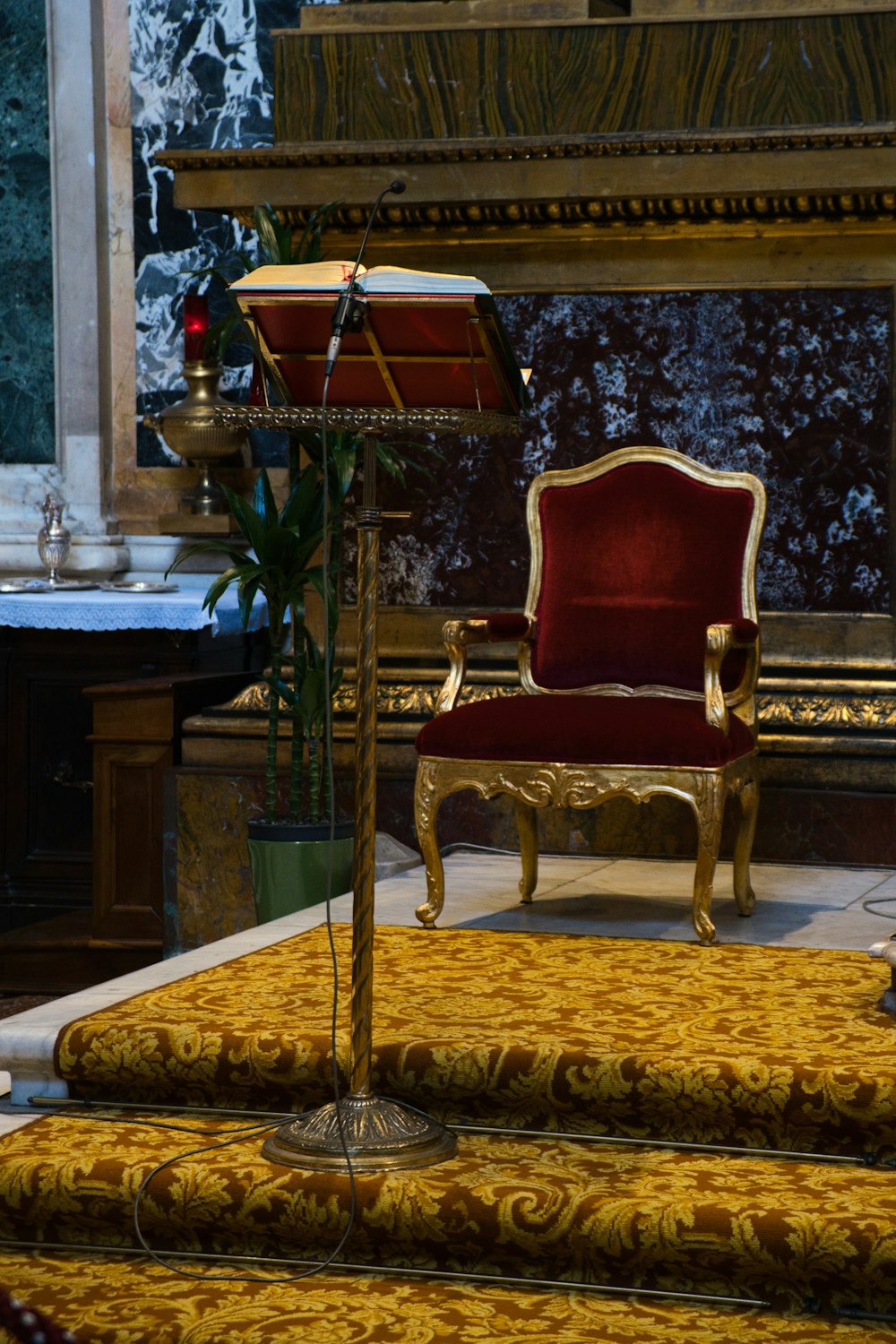 a red chair sitting on top of a carpet covered floor