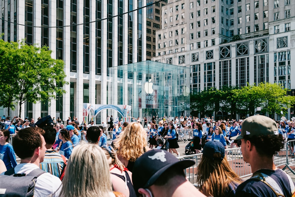 a crowd of people sitting in chairs in front of a building