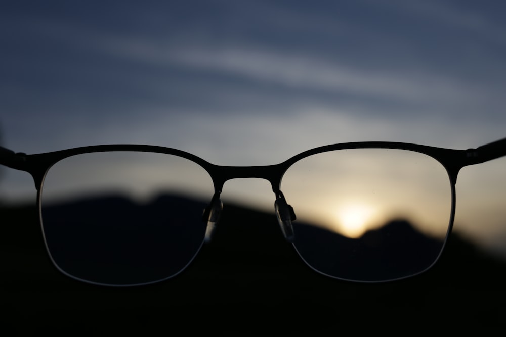 a pair of glasses sitting on top of a table