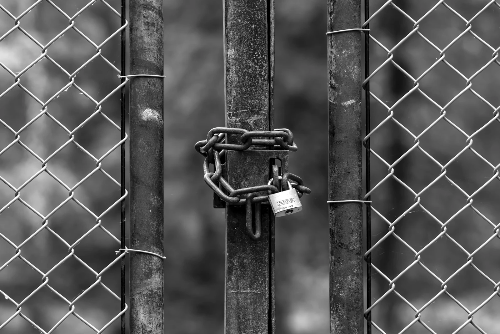 A chain link fence with a padlock on it