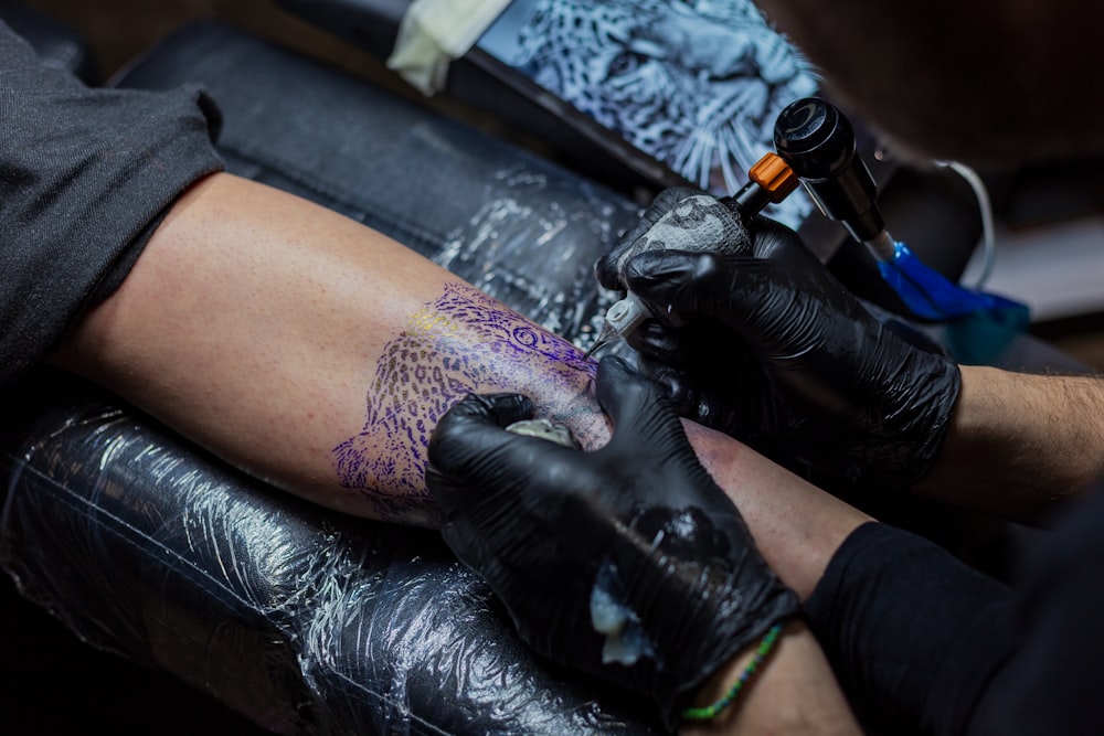 a person getting a tattoo on their arm