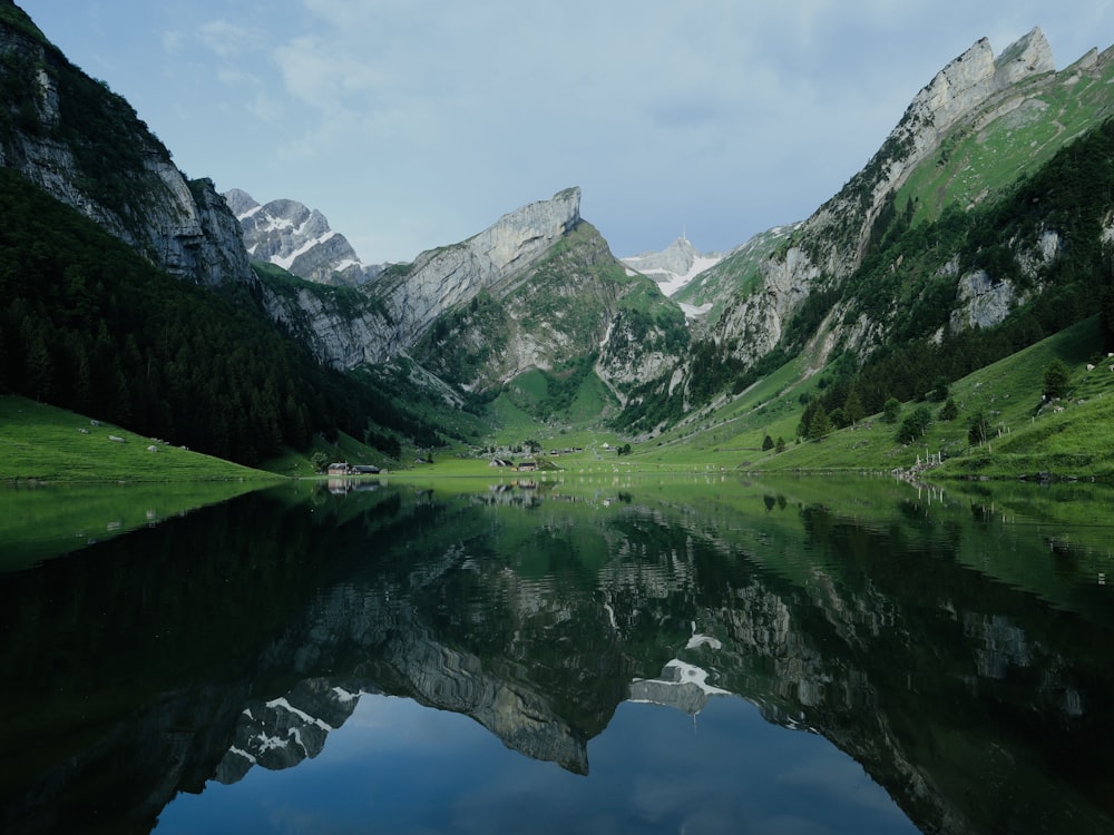 a mountain range with a lake in the foreground