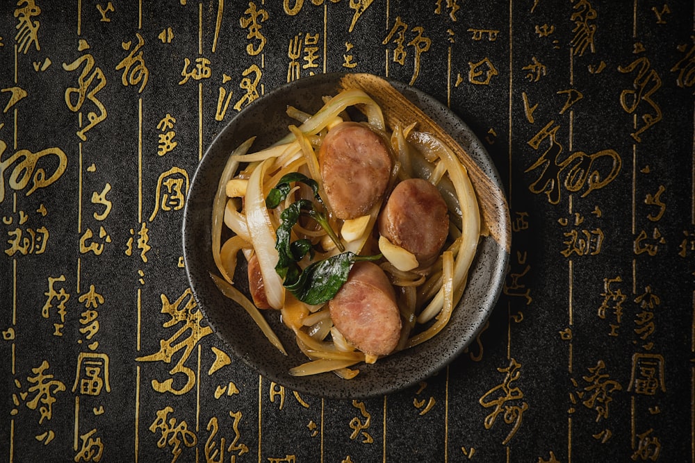 a bowl of food with noodles and meat