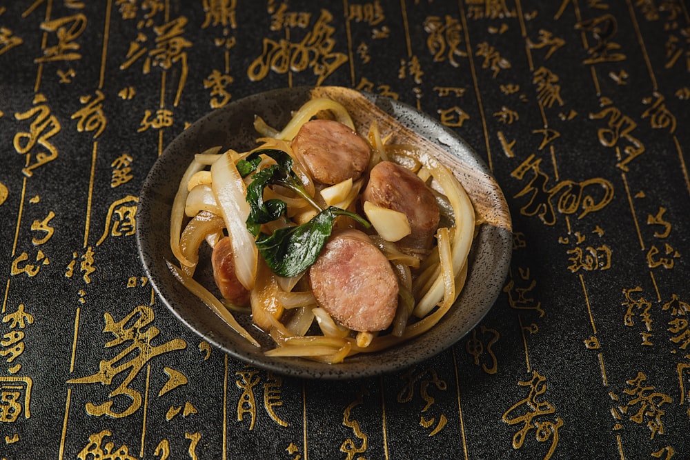 a bowl filled with noodles and meat on top of a table