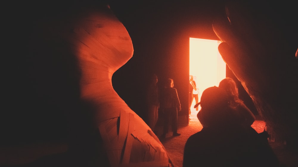 a group of people standing in a dark tunnel