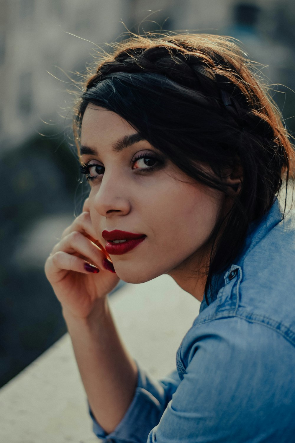 a woman with dark hair and red lipstick
