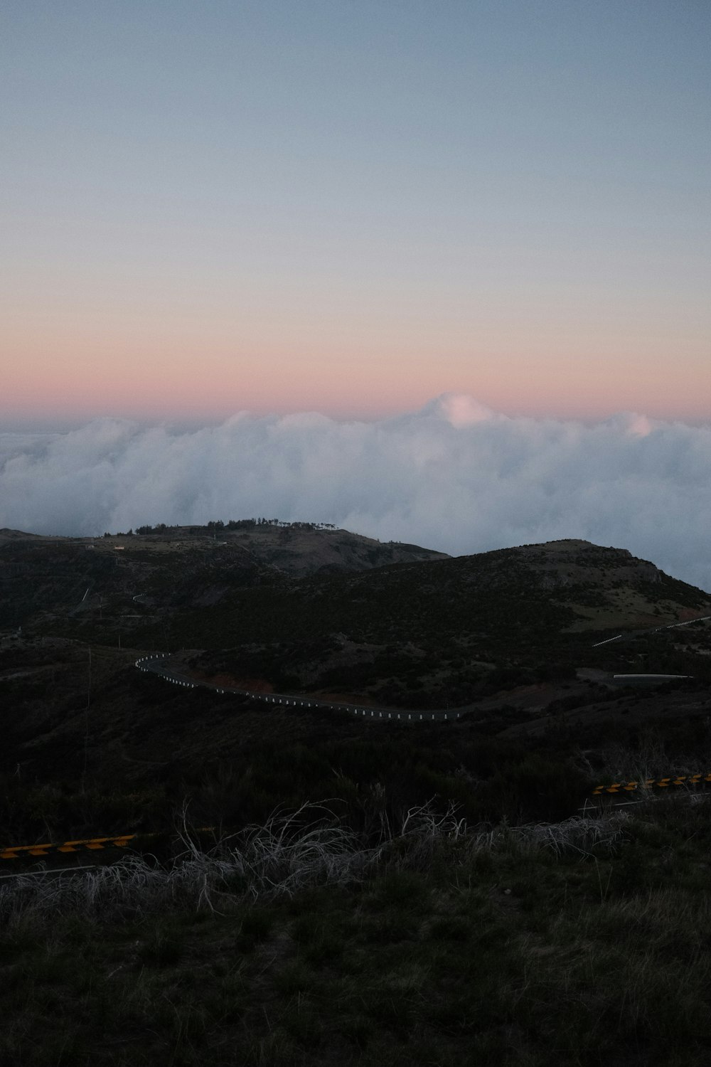 a view of a hill with clouds in the sky