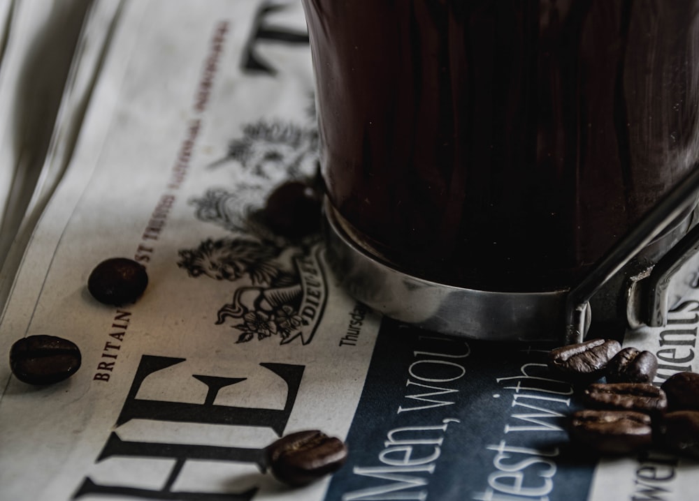 a cup of coffee sitting on top of a newspaper