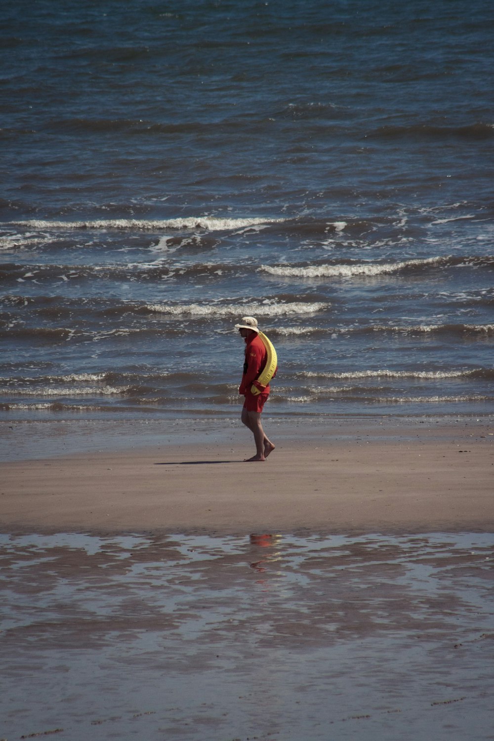 a person walking on a beach near the ocean