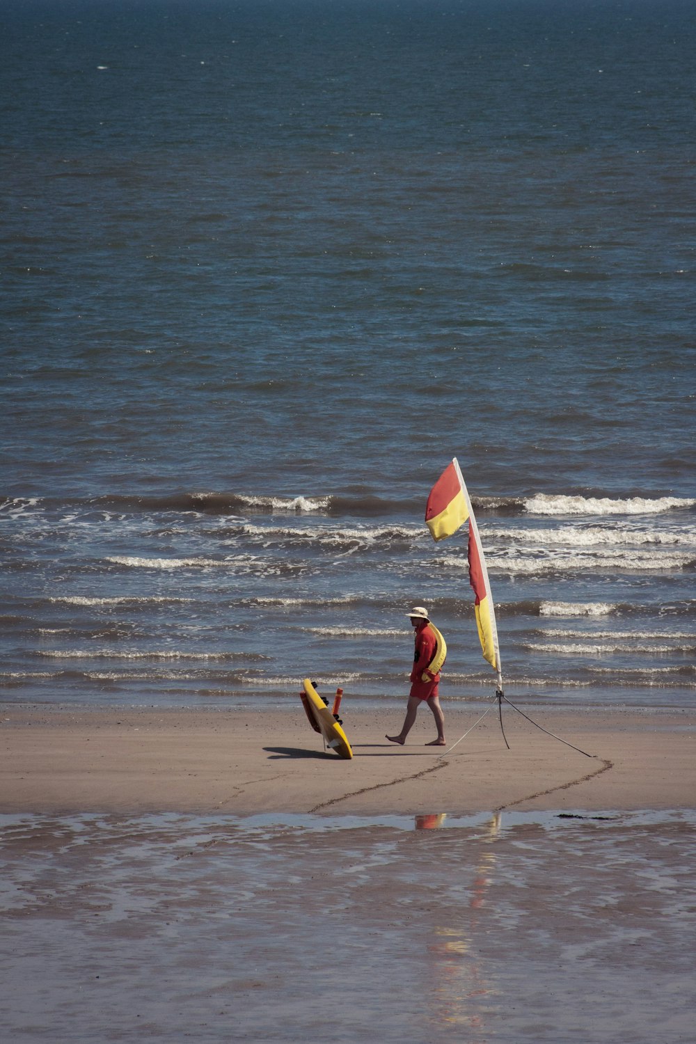 a couple of people on a beach with a kite