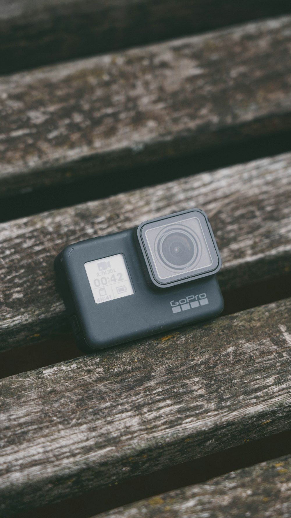 a camera sitting on top of a wooden bench